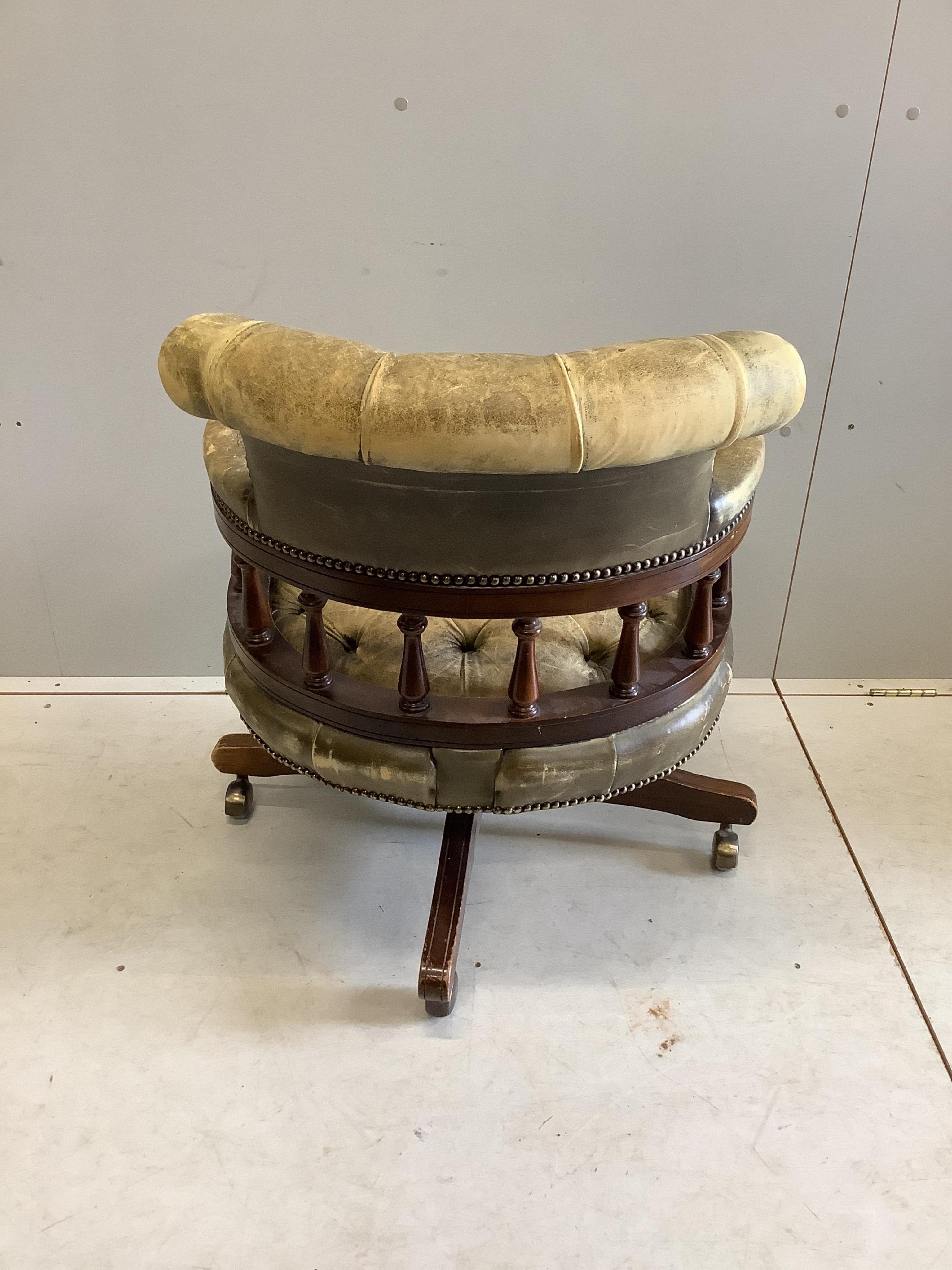 A reproduction Victorian style buttoned leather beech swivel desk chair, width 61cm, depth 58cm, height 80cm. Condition - poor